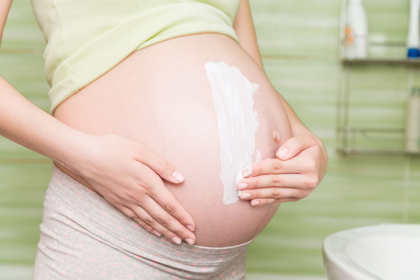 Pregnant Woman Applying Anti-Stretch Marks Cream
